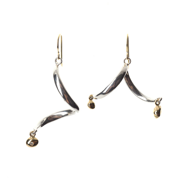 The InsideOut earrings in sterling silver are accented by two 18k yellow gold elements, each setting a small diamond. This playful, asymmetrical design exudes movement and artistic personality.  • Sterling silver, 18k yellow gold, diamonds 0.03 cts