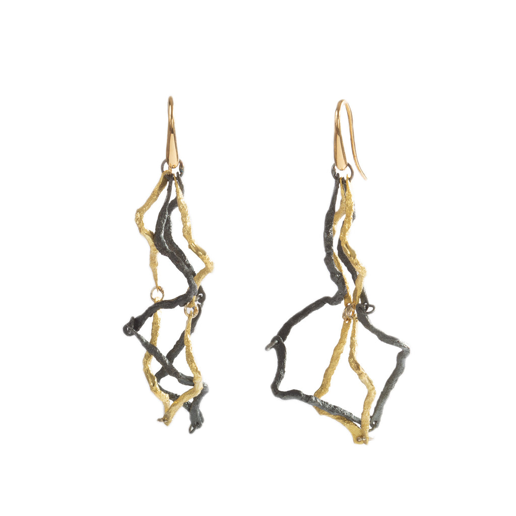 These Respiro earrings in 18k yellow gold and blackened sterling silver are a unique piece for special occasions. This is art to wear, combining the warmth of gold with the boldness of blackened silver for a striking and elegant look.  • 18k yellow gold, blackened sterling silver  • Length: 2.5"