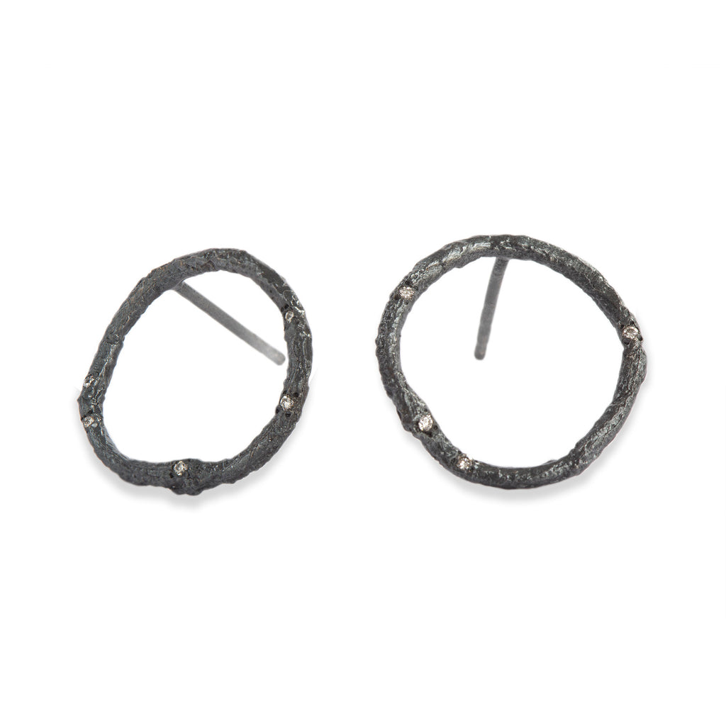 These Svelare circle earrings, crafted in textured blackened sterling silver, serve as a delicate accent to your attire, adorned with tiny diamonds.  • Blackened sterling silver, diamonds ct: 0.08  • Post backs  • Height: 0.75 inches