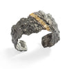 Raw You Blackened Sterling Silver With Diamonds Cuff by Emanuela Duca - A fusion of raw sophistication and contemporary elegance. Crafted from highly textured blackened sterling silver, this piece features seven 1.5mm diamonds set against a backdrop of striking darkness. Accentuated by a single 18k yellow gold element, it embodies modernity with a touch of edge. Elevate your style with this unique and captivating design.