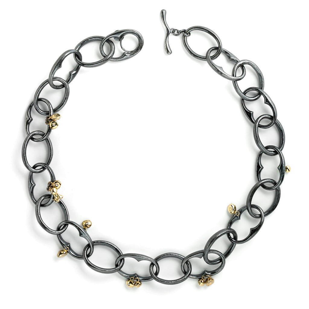 The InsideOut necklace features bold blackened sterling silver links accented with 18k yellow gold elements, adorned with small diamonds. This striking piece combines fashion and movement with a rock &amp; roll edge, making it a standout accessory.  • Blackened sterling silver, 18k yellow gold, diamonds 0.09 cts  • Length: 20"