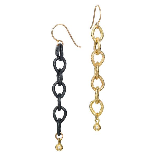 The InsideOut earrings showcase one earring in 18k yellow gold and one in blackened sterling silver, each accented by a gold element with a small diamond. This unique combination blends elegance with a playful edge, making them perfect for adding a touch of flair to any outfit.  • 18k yellow gold, blackened sterling silver, diamonds 0.03 cts  • Length: 2.75 inches